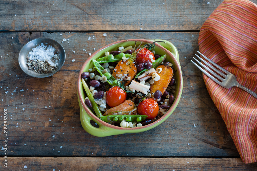 Vegetable bowl on rustic wood background with salt, fork and napkin. Vegetable bowl on rustic wood background with salt, fork and napkin.
