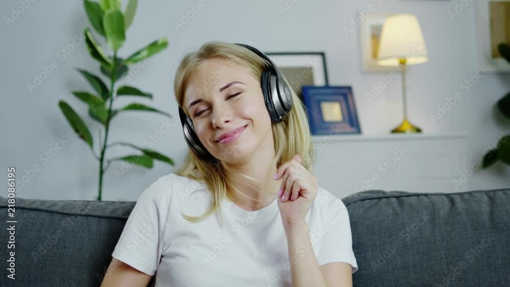 Young pretty woman enjoying music with headphones. Young pretty woman enjoying music with headphones.