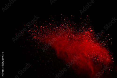 Abstract of red powder explosion on black background. Red powder splatted isolate. Colored cloud. Colored dust explode. Paint Holi.