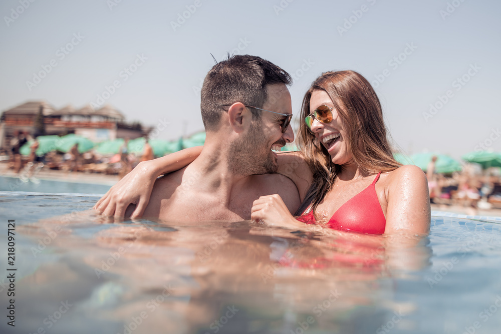 Fototapeta premium Couple having fun in a swimming pool