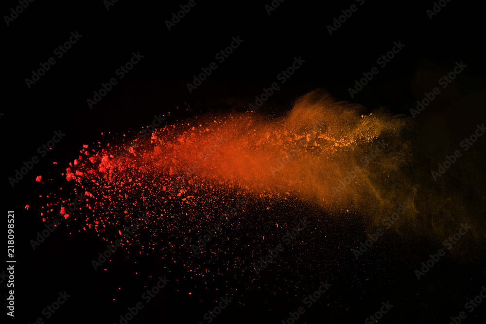 Explosion of colored powder isolated on black background. Power or clouds splatted. Freez motion of orange dust exploding. - obrazy, fototapety, plakaty 