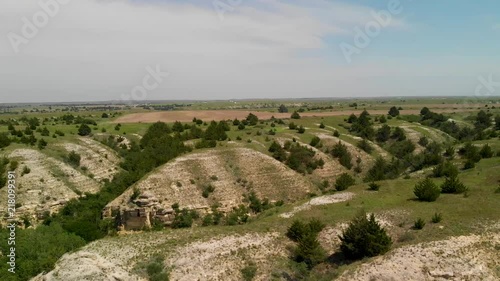 An aerial reveal of the cliffs and hills at Cedar Bluff Reservoir cliffs in Kansas. photo