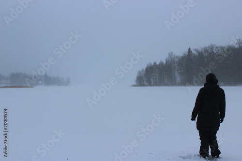 woman from the back on a frozen lake in estonia