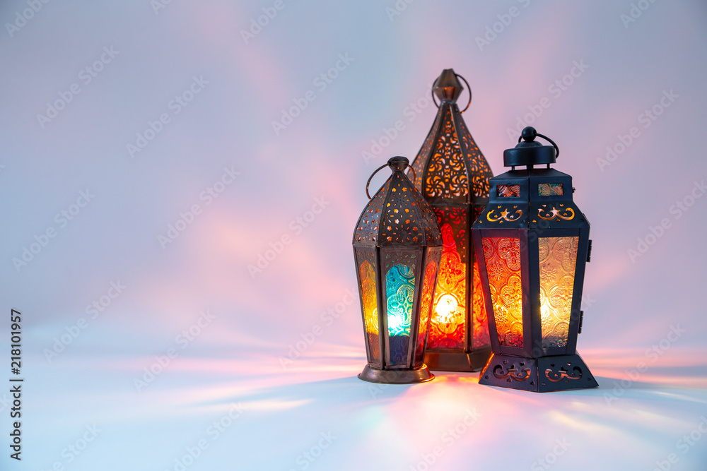 Arabic, Moroccan lanterns and dates in low light, on white background with colors reflections and copy space. Eid and Ramadan concept. Arabic, Moroccan lanterns and dates in low light, on white background with colors reflections and copy space. Eid and Ramadan concept.
