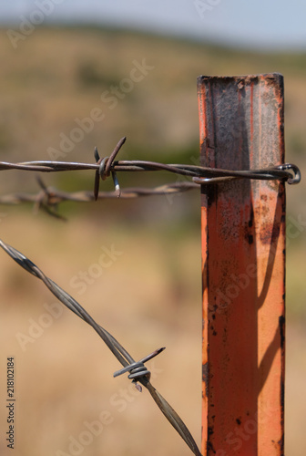 Barbed wire close up with post