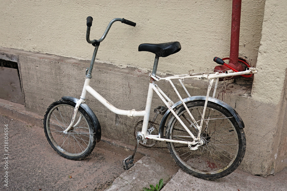 bicycle parked on the steps near the wall