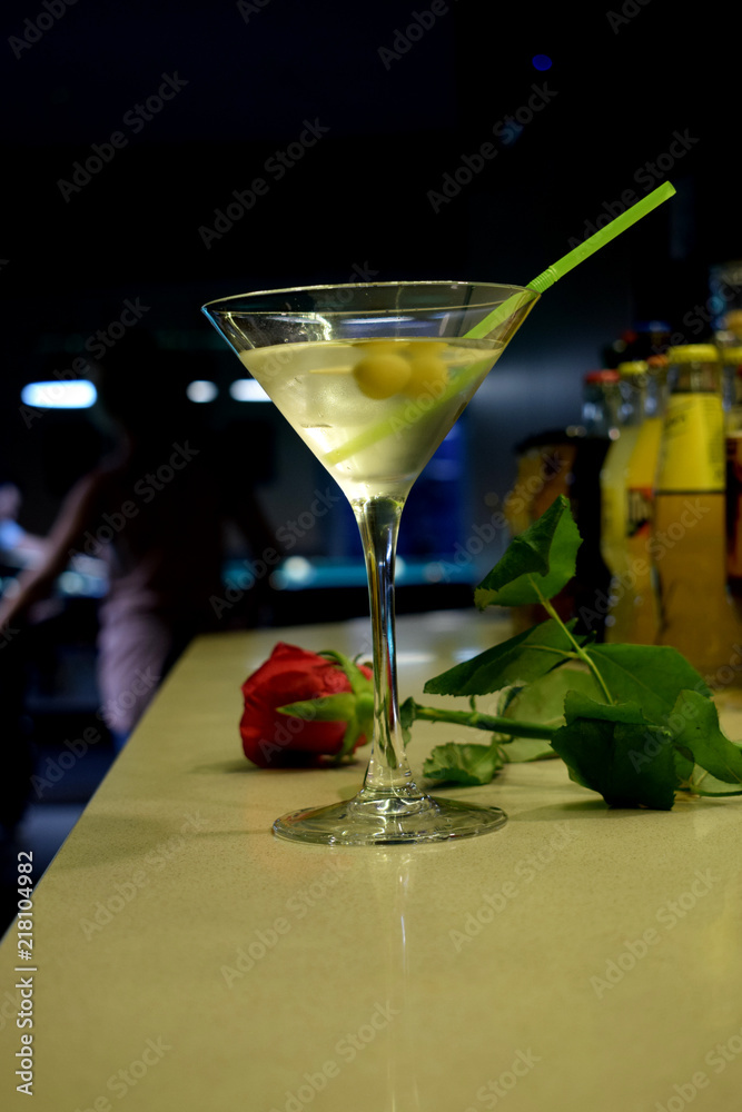Red Rose and Martini Cocktail with Olives with  the Background of  Billiard Table