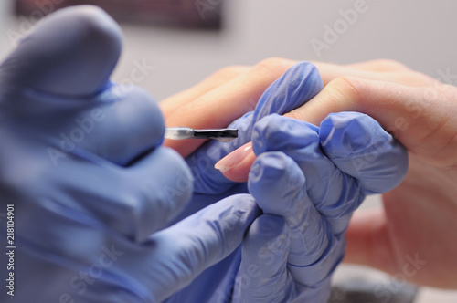 Professional manicure process in beauty salon.