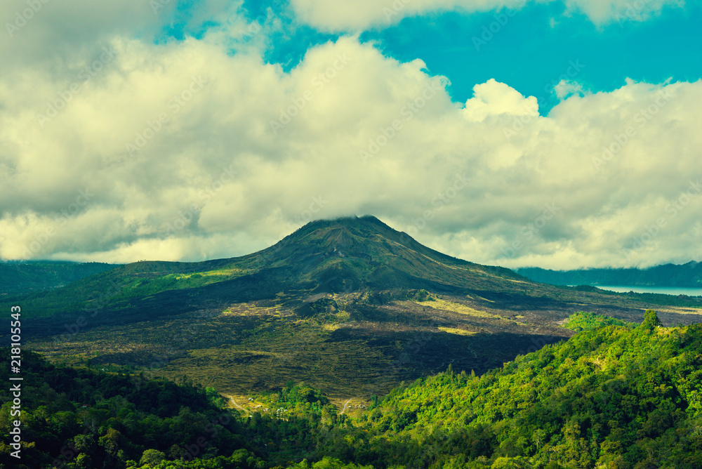 Beautiful banner with mountain landscape and tropical forest. Landscape of Batur volcano on Bali island, Indonesia. View far away beauty, inspiring mountain. Summer day. Instagram filter photo.