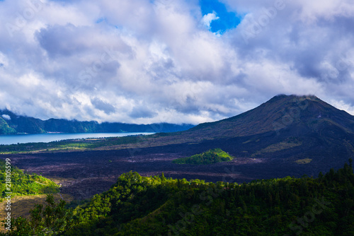Summer background. Rural sunrise landscape. Countryside and green tropical forest. Natural background. Landscape of Batur volcano on Bali island, Indonesia. Azure lake in the mountains. © eskstock