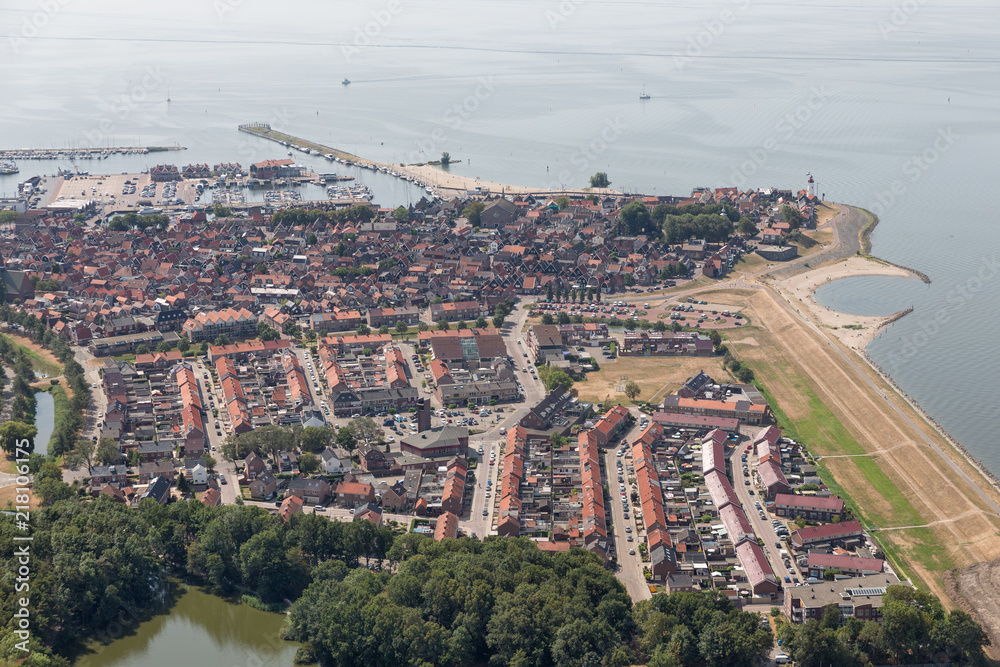Aerial view Dutch fishing village with harbor, lighthouse and residential area