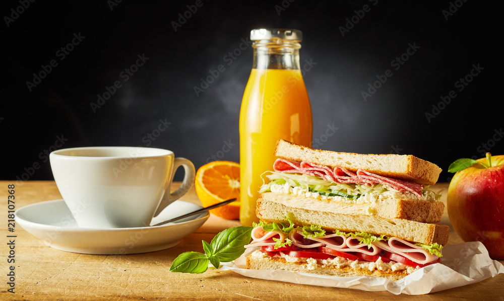 Sandwich, fruit, juice and coffee for breakfast