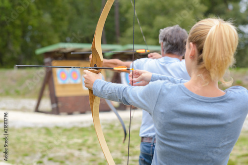 Bild auf Leinwand Couple during archery practice