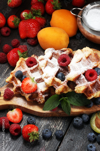 Traditional belgian waffles with fresh mint, sugar and raspberries.