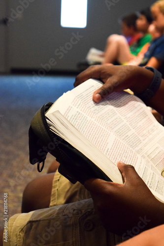 multi-ethnic kids reading Bible in church VBS 