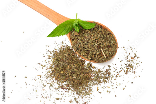 Fresh mint leaves with dried mint in wooden spoon isolated on white background