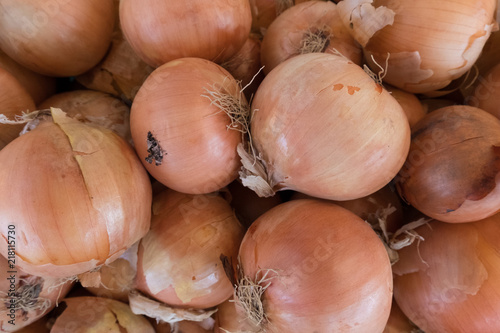 Fresh brown onion stand at a street organic food market.