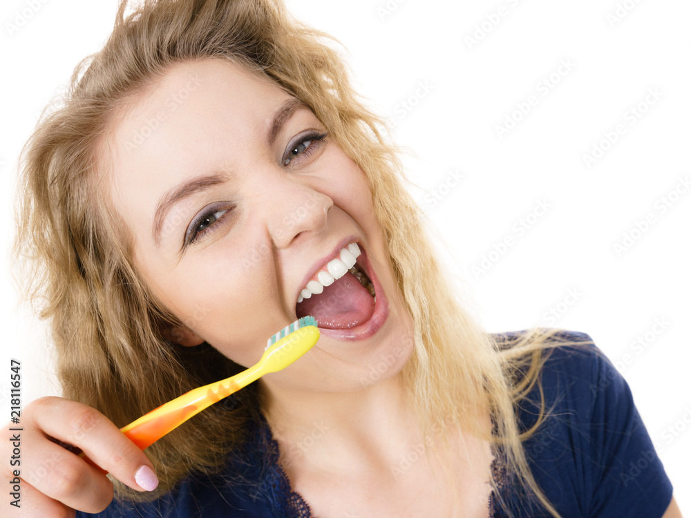 Happy positive woman brushing teeth, isolated Happy positive woman brushing teeth, isolated