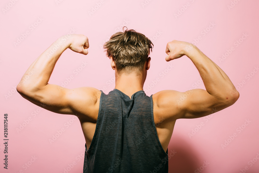 Biceps concept. Athlete show biceps and triceps, back view. Man flex arms  with biceps. Biceps muscle of arms Stock Photo