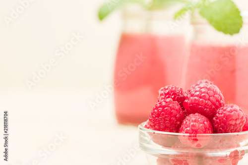 Raspberry smoothie close up photography with fresh summer blended cocktail and ripe berries.