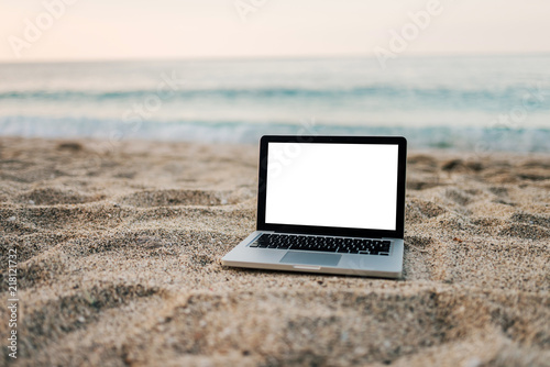 Fototapeta Naklejka Na Ścianę i Meble -  Laptop on the sand beach.