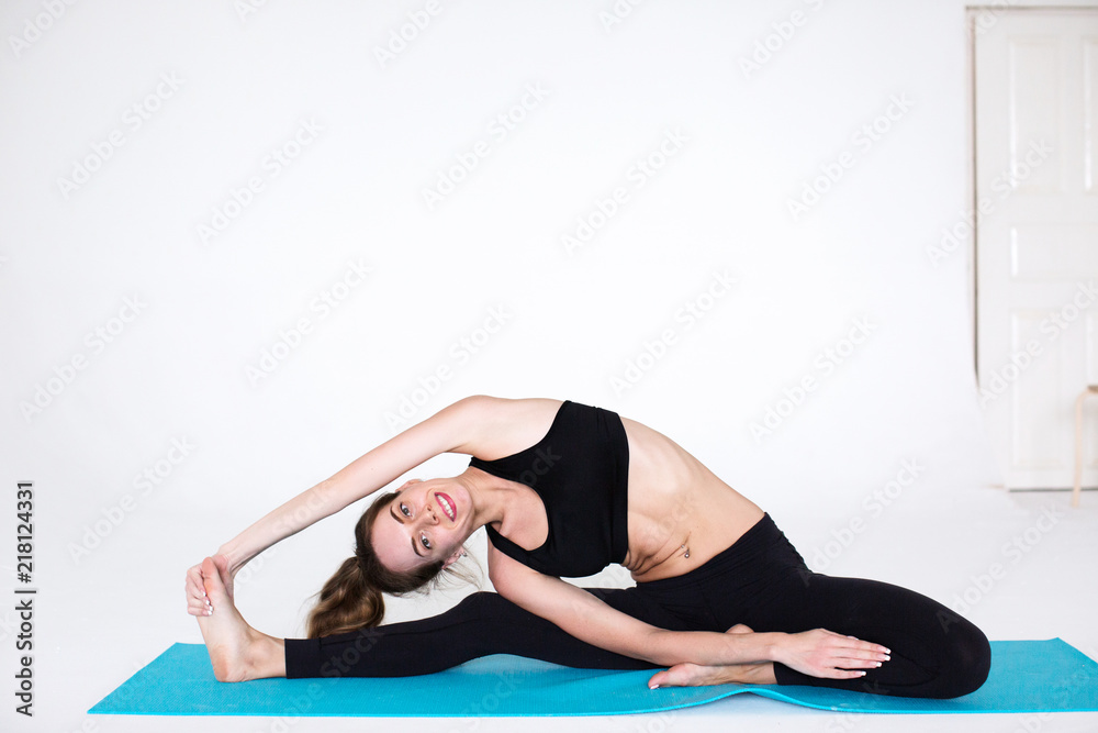 Smiling woman exercising on a fitness mat Smiling woman exercising on a fitness mat