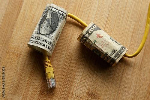 The cost of internet data plans in America concept image consisting of USA dollar bills and an Ethernet cable.  This image can also be used to represent net neutrality or online income.  photo