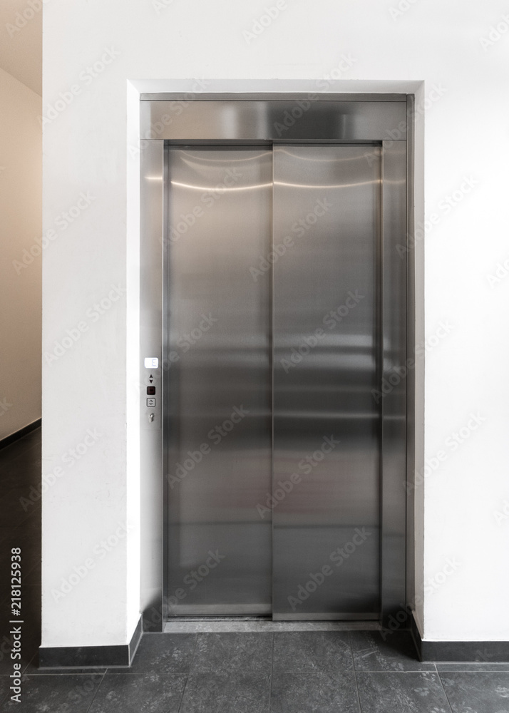 Modern elevator in apartment building, New elevator in operation, European modern stainless steel elevator in block of flats Modern elevator in apartment building, New elevator in operation, European modern stainless steel elevator in block of flats