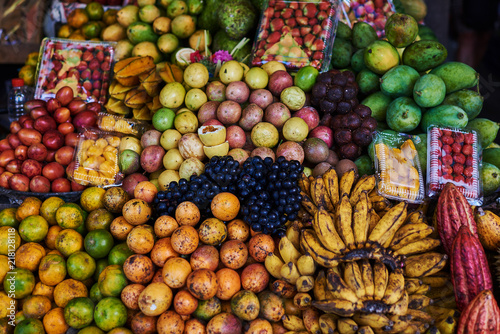 Fototapeta Naklejka Na Ścianę i Meble -  Asian exotic fruits. Market stall with variety of organic fruits. Colorful fruits in the marketplace. Bright summer background. Healthy, organic food. Natural nutrition for diet. Selective focus.