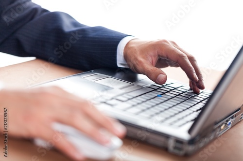 Closeup of a Businessman Typing on a Laptop Keyboard