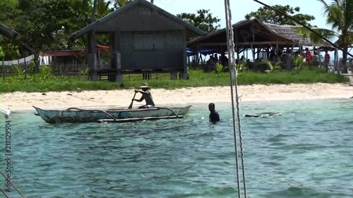 Tourist boats arriving at Pamilacan island and being greeted by local fishermen selling their fresh goods. photo