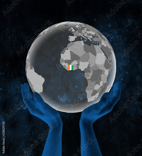 Ivory Coast on globe in hands in space photo