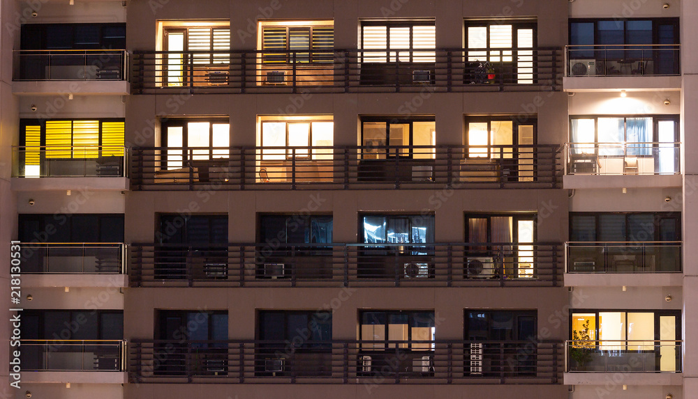 Apartment windows at night in the city. Apartment windows at night in the city.