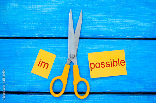 Impossible Is Possible Concept. card with the text impossible, scissors cut a word to them. success and challenge concept. I can, goal achievement, potential, overcoming photo