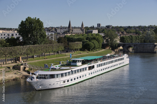 Cruise harbor on river Seine in Poissy, near Paris, surrounded by collegiate and old stone bridge