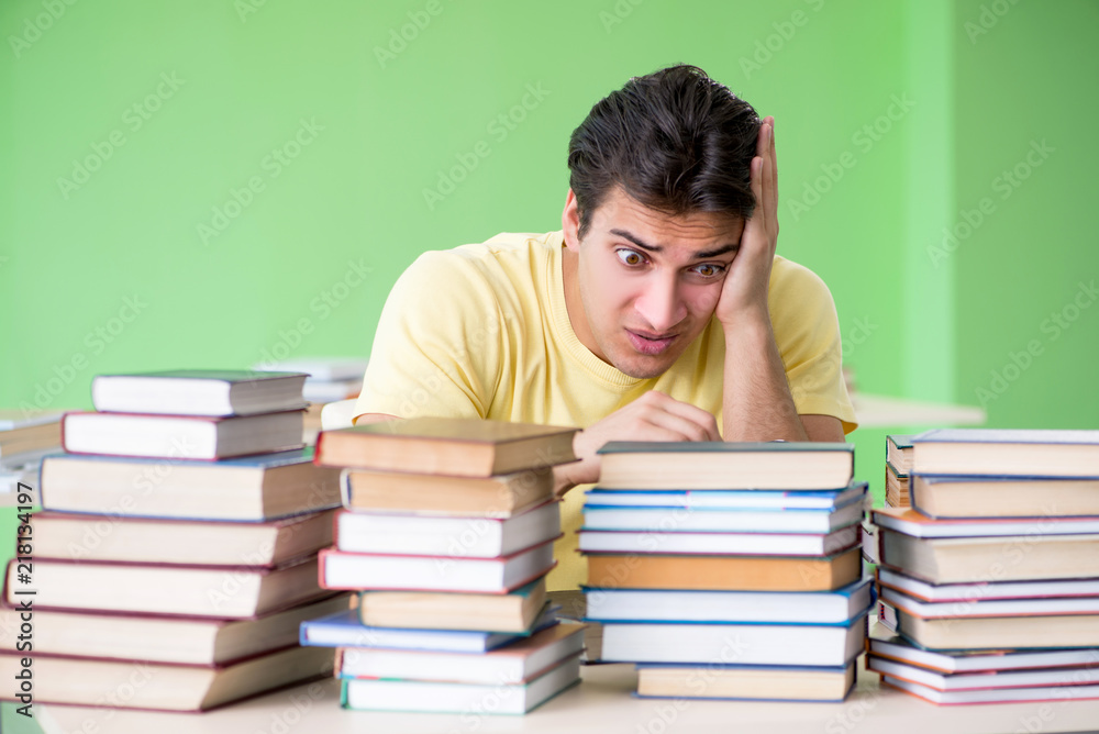 Student with too many books to read before exam Student with too many books to read before exam