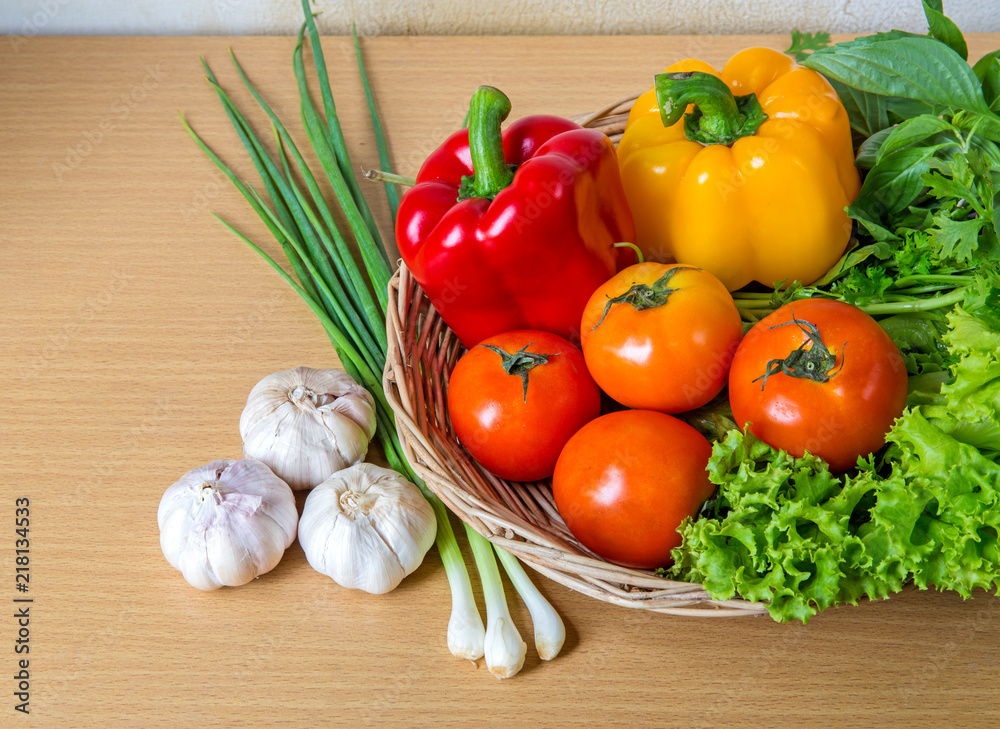 Organic vegetables in the wicker basket on wooden background Organic vegetables in the wicker basket on wooden background