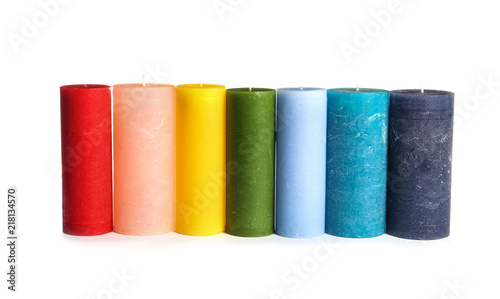 Different colorful wax candles on white background