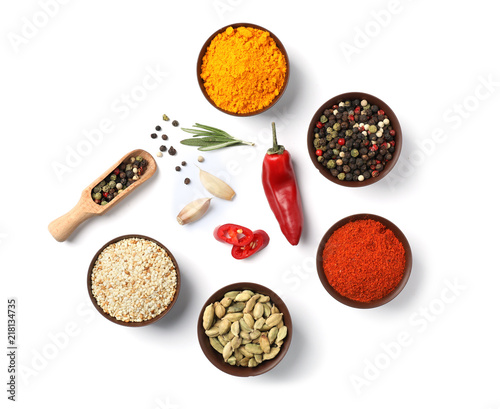 Composition with different aromatic spices on white background, top view