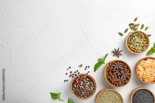 Flat lay composition with different aromatic spices and space for text on light background