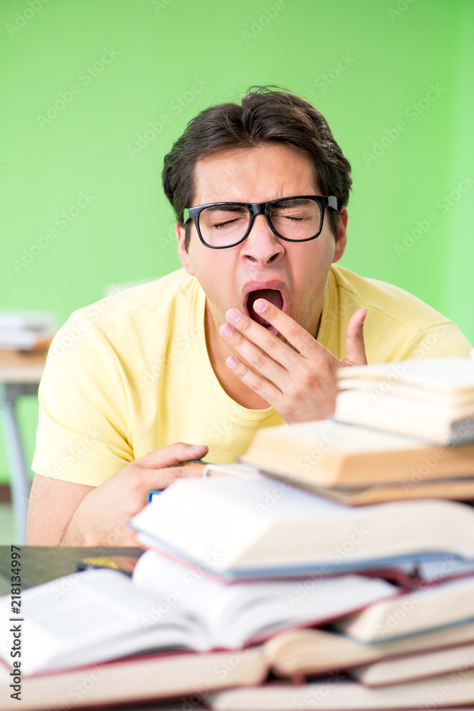 Student with too many books to read before exam Student with too many books to read before exam