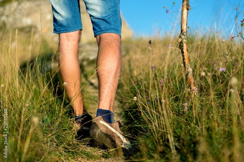 Closeup of Man's Legs Walking Through the Field