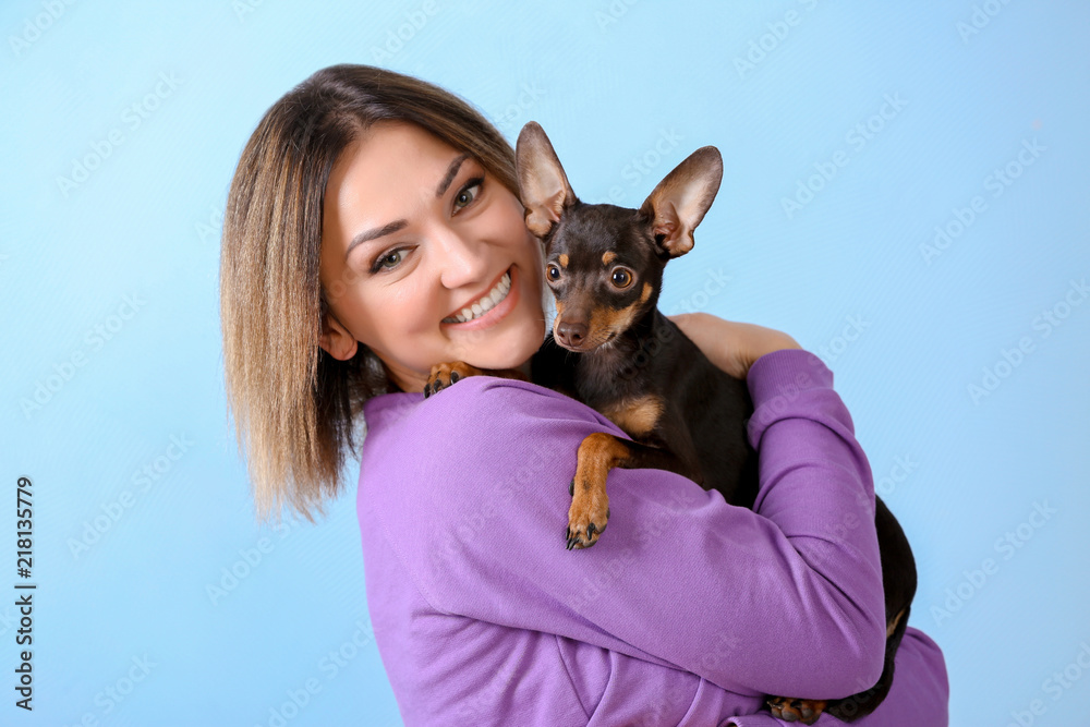 Young beautiful smiling woman with cute dog on color background Young beautiful smiling woman with cute dog on color background
