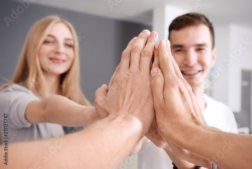 People putting hands togeth...