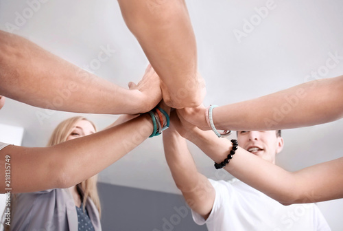 People putting hands togeth...