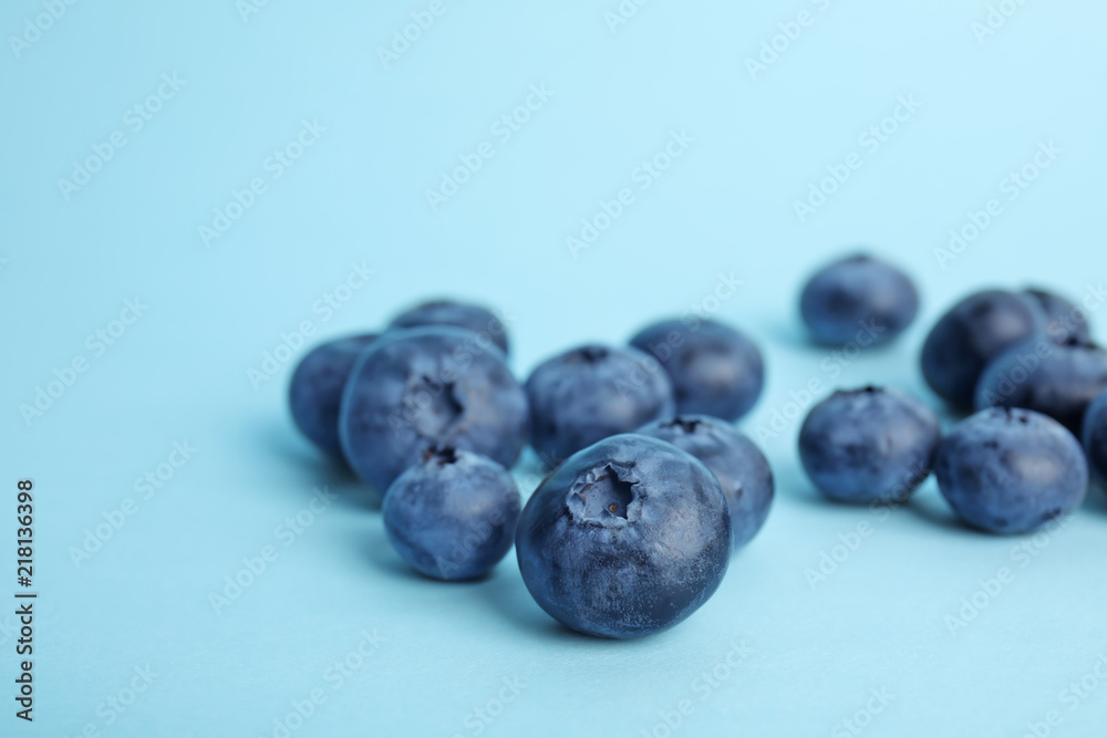 Tasty ripe blueberry on color background, closeup Tasty ripe blueberry on color background, closeup