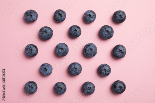 Flat lay composition with tasty blueberry on color background