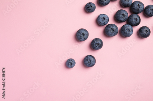 Flat lay composition with tasty blueberry and space for text on color background