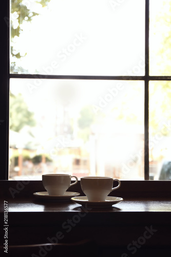 Cups of fresh aromatic coffee on table near window © New Africa