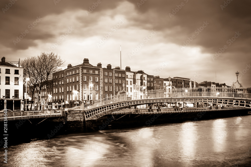 Ha'Penny Bridge over the River Liffey in Dublin Ireland seen a dusk